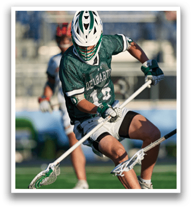 A man holding a lacrosse stick. Description generated by AI