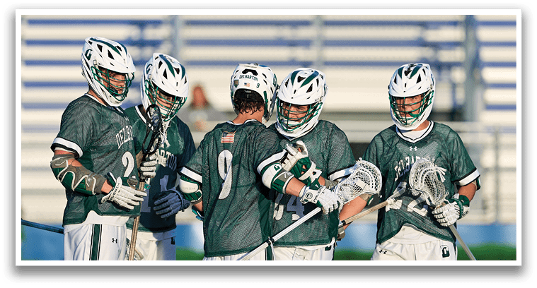 A group of young men in green and white uniforms pose for a picture. Description generated by AI