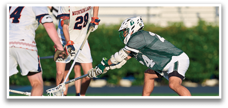 A group of young men wearing green and white uniforms. Description generated by AI