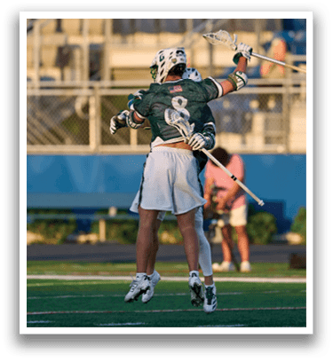 A man holding a lacrosse stick. Description generated by AI