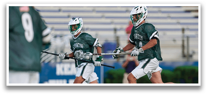 Five men wearing green jerseys with the number 11, 18, 19, 24, and 34 on them. Description generated by AI