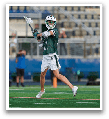 A man holding a lacrosse stick. Description generated by AI