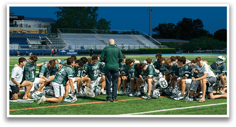 A group of young men in green and white uniforms pose for a picture. Description generated by AI