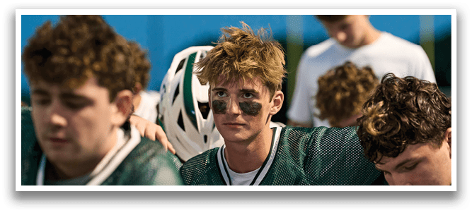 A group of people standing together, one of them wearing a jersey with the number 33. Description generated by AI