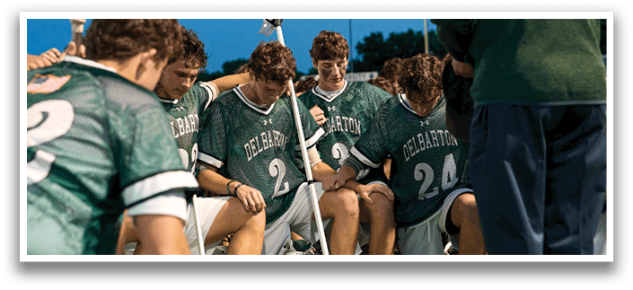 Five men wearing green jerseys with the number 11, 18, 19, 24, and 34 on them. Description generated by AI
