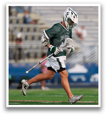 A man holding a lacrosse stick. Description generated by AI