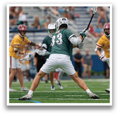 A man holding a lacrosse net. Description generated by AI