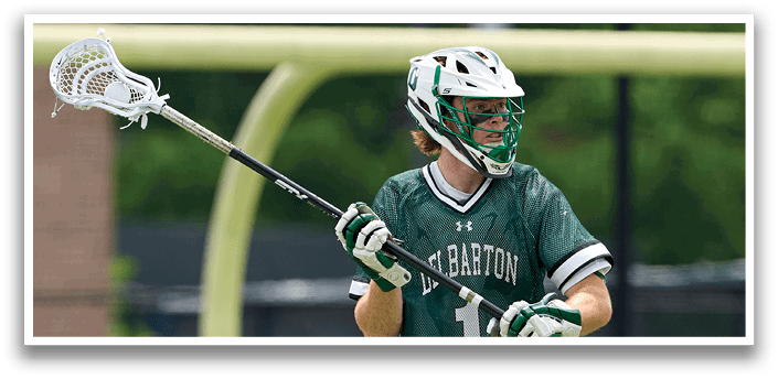 A man wearing a green and white jersey is running on a field. Description generated by AI