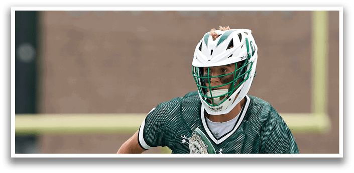A man wearing a green and white jersey is running on a field. Description generated by AI
