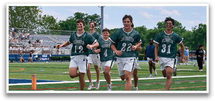 A group of people wearing green and white shirts. Description generated by AI