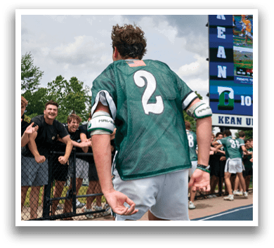 A man and woman are standing next to a football player. Description generated by AI