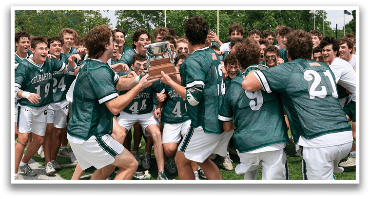 A group of young men in green and white uniforms pose for a picture. Description generated by AI
