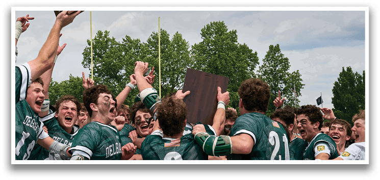 A group of young men wearing green and white uniforms. Description generated by AI