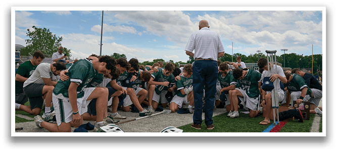 A group of people standing together, one of them wearing a jersey with the number 33. Description generated by AI