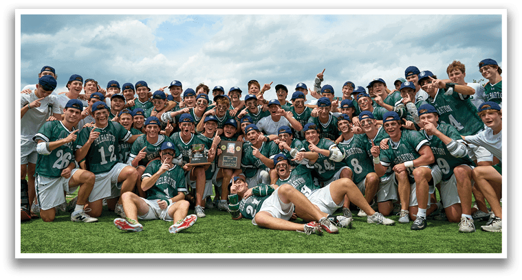 A group of young men in green and white uniforms pose for a picture. Description generated by AI
