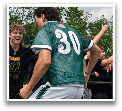 A man and a woman wearing Delaware jerseys. Description generated by AI