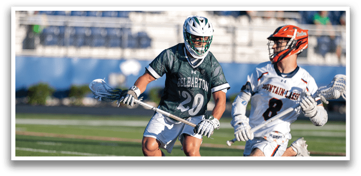 Two men playing a game of lacrosse. Description generated by AI