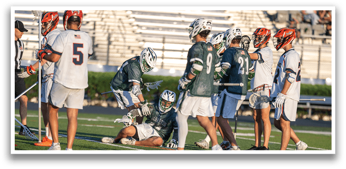A group of men playing lacrosse. Description generated by AI