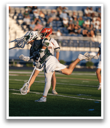 A man wearing a green and white shirt and white shorts is running on a field. Description generated by AI