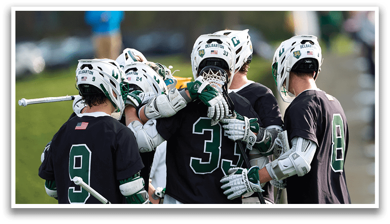 A group of men wearing black and white uniforms hugging each other. Description generated by AI