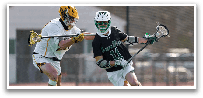A man holding a lacrosse stick. Description generated by AI