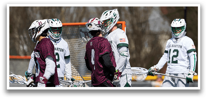 A group of people wearing green and white uniforms are standing on a field. Description generated by AI
