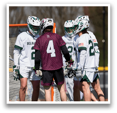 Three people wearing green and white uniforms. Description generated by AI