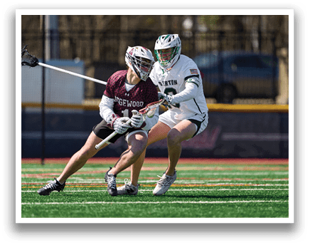 Two people playing a game of lacrosse. Description generated by AI