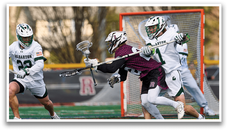 A group of men playing lacrosse on a field. Description generated by AI
