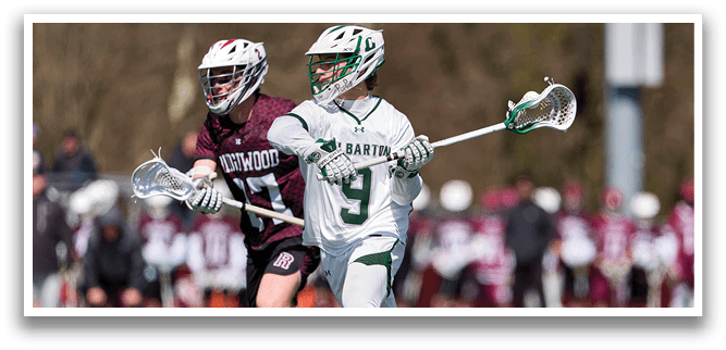 A man in a white uniform is playing lacrosse. Description generated by AI