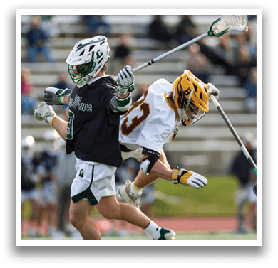 Two men playing lacrosse on a field. Description generated by AI