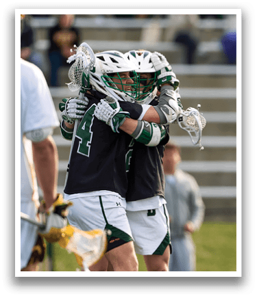 Two men hugging on a field. Description generated by AI