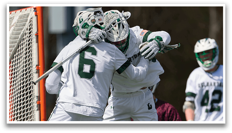 Two men are playing hockey, one is holding the other in a headlock. Description generated by AI