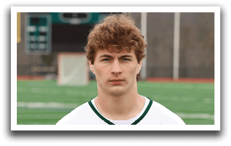 A man wearing a white and green Delaware jersey. Description generated by AI