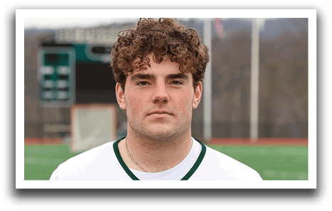 A man wearing a white and green Delaware shirt. Description generated by AI