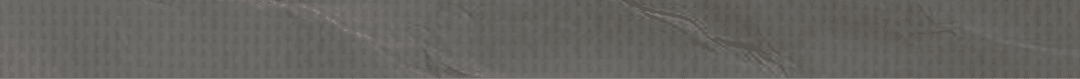 A wrinkled piece of paper with a grayish tint. Description generated by AI
