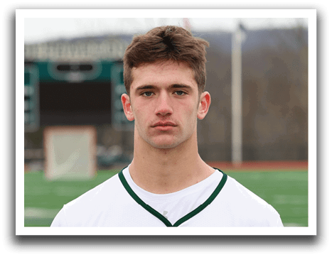 A man wearing a white and green jersey with the number 8 on it. Description generated by AI