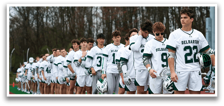 A group of young men wearing white and green uniforms. Description generated by AI