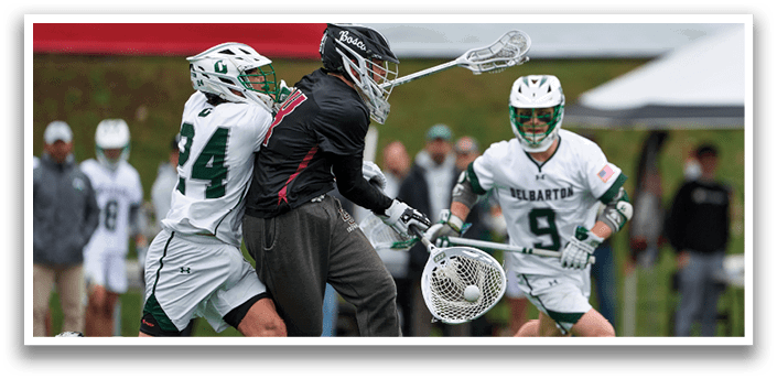 Two men playing lacrosse. Description generated by AI