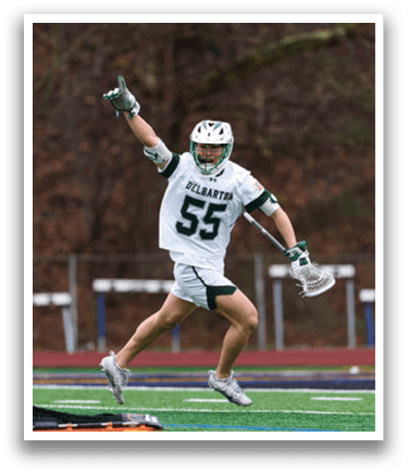 A man wearing a white and green jersey is jumping in the air. Description generated by AI