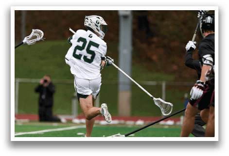 A man in a white jersey with the number 25 on it is running with a lacrosse stick. Description generated by AI