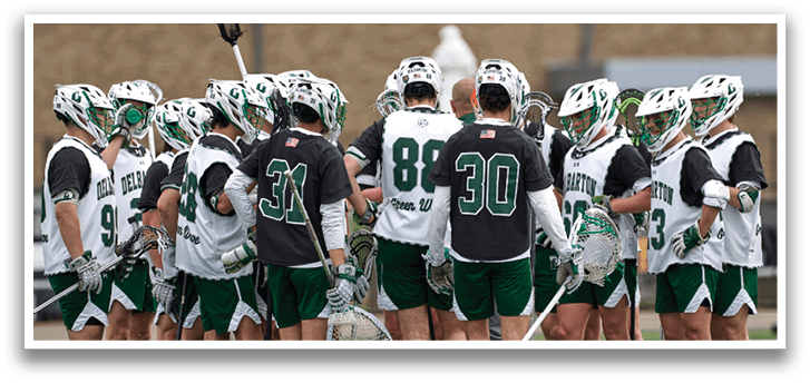 A group of people wearing green and white uniforms. Description generated by AI