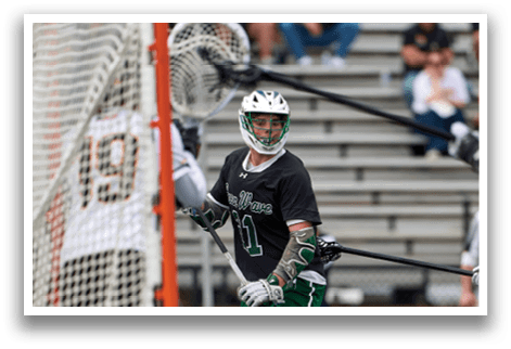A man in a green and white uniform is playing hockey. Description generated by AI