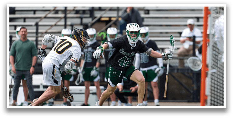 A man in a green and white uniform is running towards a goal. Description generated by AI