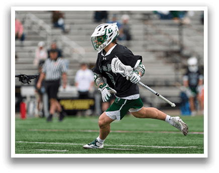 A man running on a field with a black and white helmet. Description generated by AI