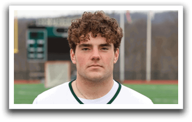 A man wearing a white and green jersey with the number 21 on it. Description generated by AI