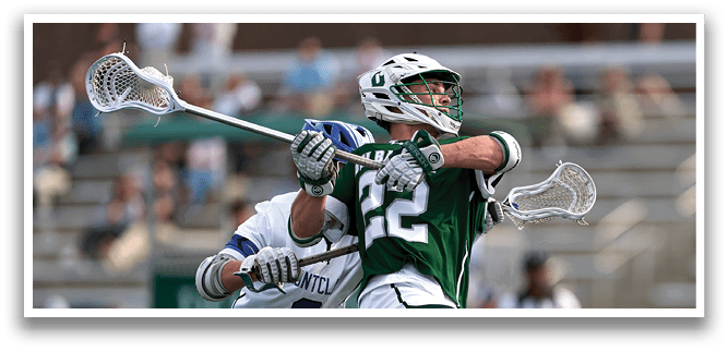 A man in a green jersey is holding a lacrosse stick. Description generated by AI