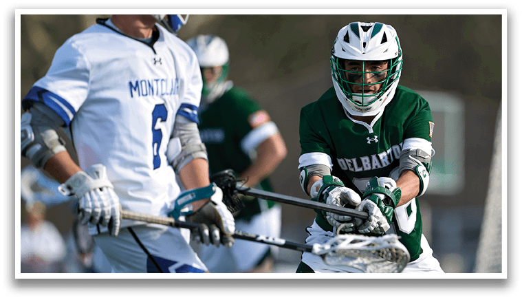 A man in a green jersey is holding a baseball bat. Description generated by AI