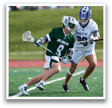 Two men playing lacrosse on a field. Description generated by AI