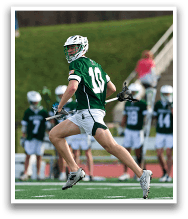 A man wearing a green shirt and white shorts is running on a field. Description generated by AI